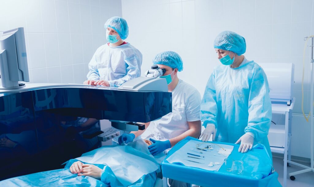 A patient and team of surgeons in the operating room during ophthalmic surgery
