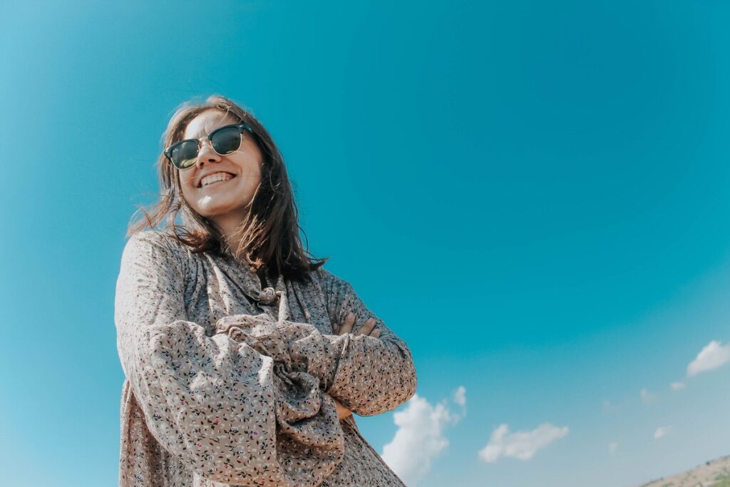 beautiful women in sunglasses on background blue sky