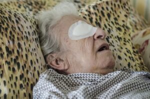 an old person with eye bandage after cataract operation