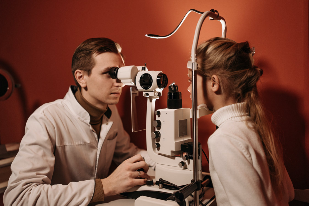 doctor examining Kid's eyes with a measurement machine.